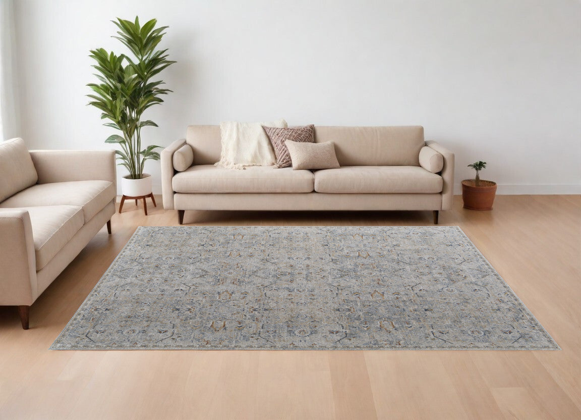 8' X 10' Ivory Tan and Blue Abstract Power Loom Worn Faded Area Rug With Fringe
